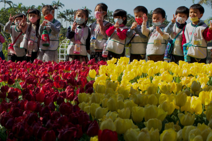 Kindergarten children pose for photographs during a tulips show