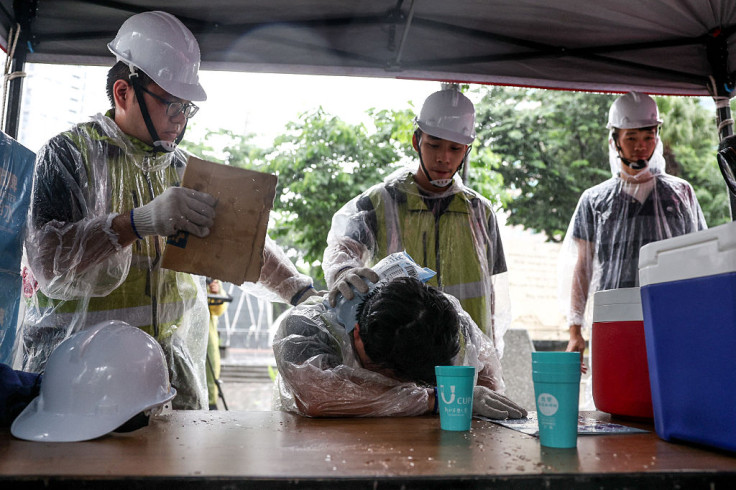 Workers use ice packs to cool a person simulating