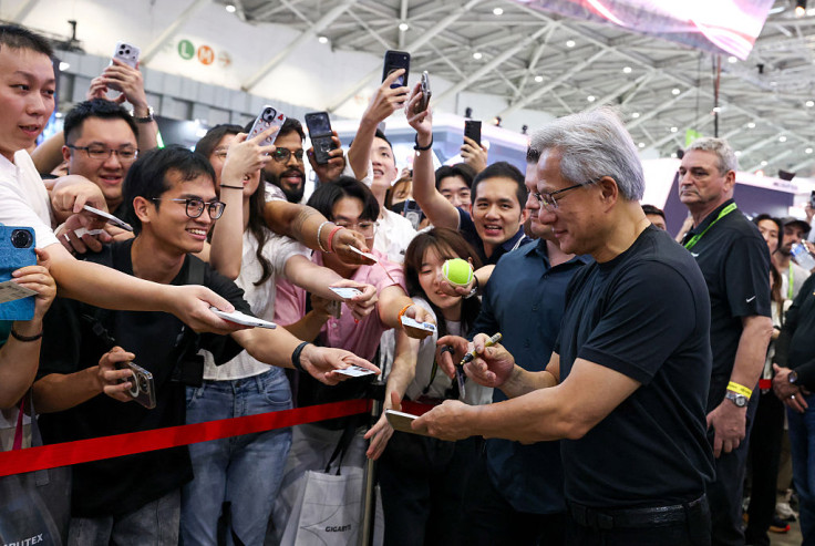Nvidia chief executive Jensen Huang signs autographs for visitors